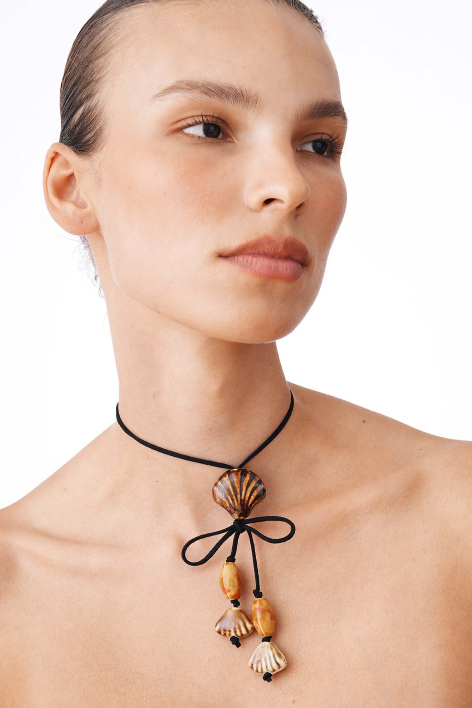 Black Suede Cord Necklace With Ceramic Seashell Tie Charm.