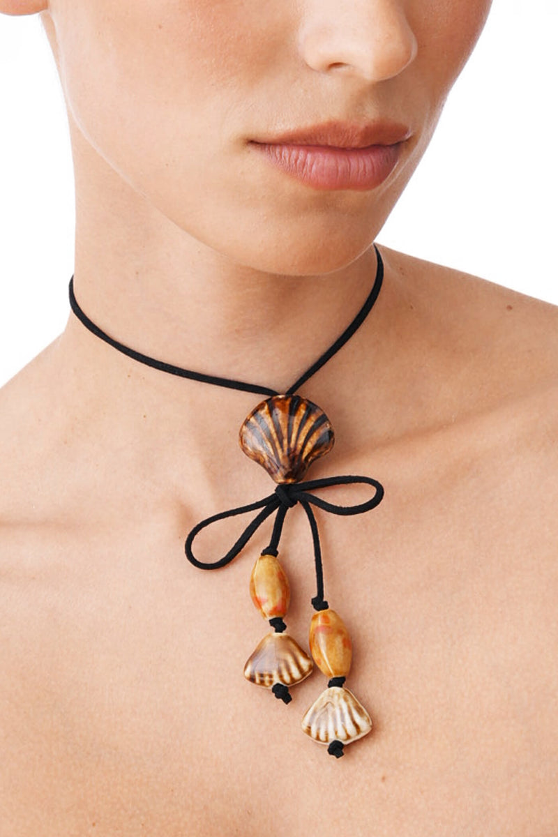 Black Suede Cord Necklace With Ceramic Seashell Tie Charm.